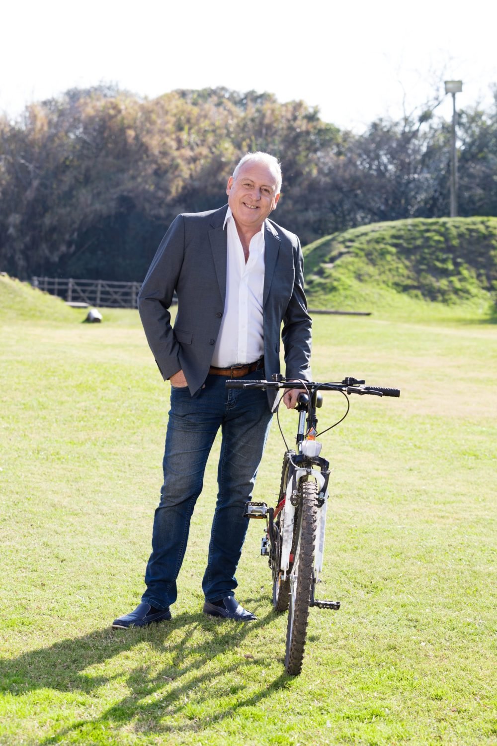 A professional staying active outdoors, bicycle in hand